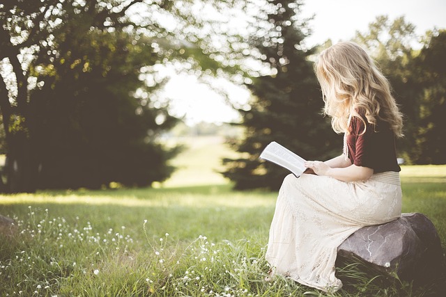 person sitting in calm meditation pose with eyes closed in a quiet learning environment